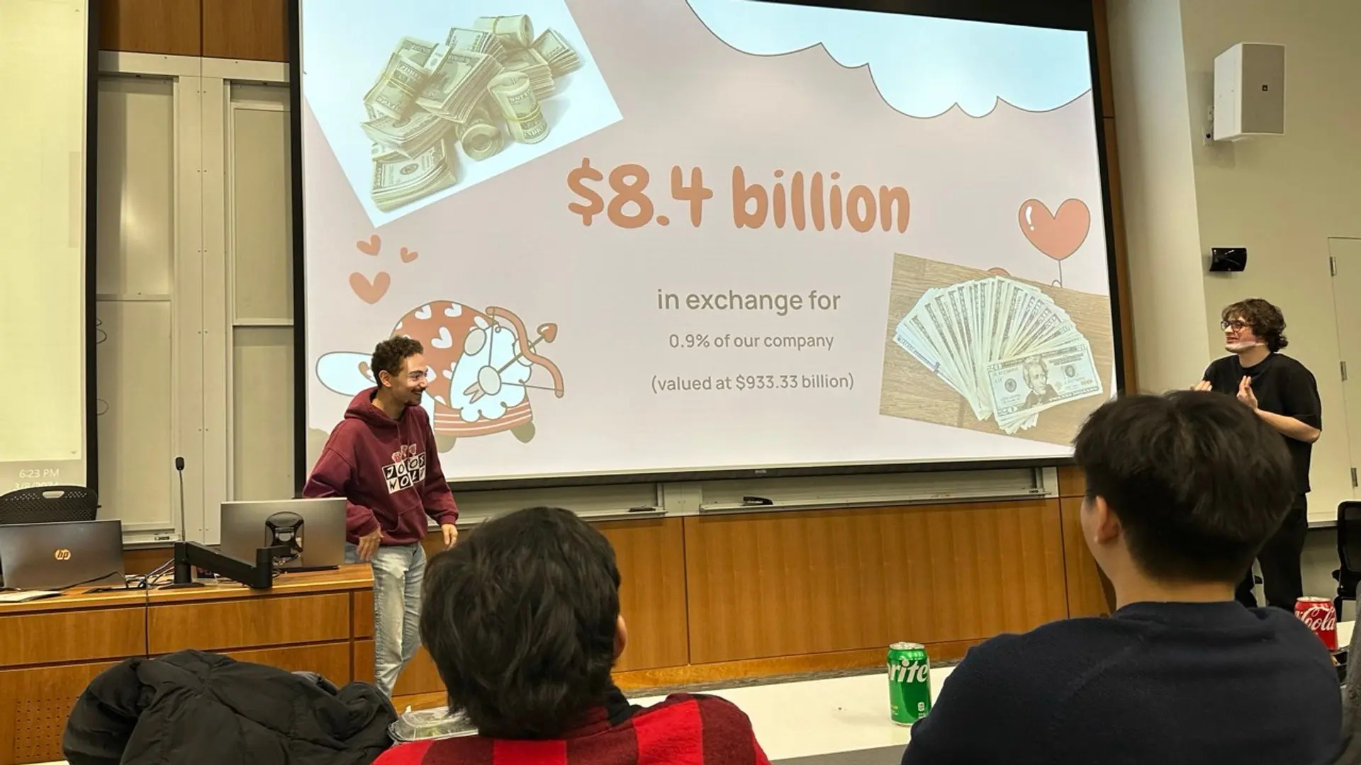 Two presenters in the midst of presenting a wacky presentation and laughing