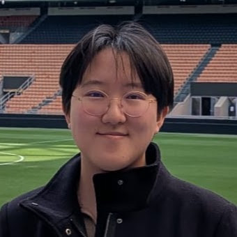 Cayden Zhan smiling inside a soccer stadium.