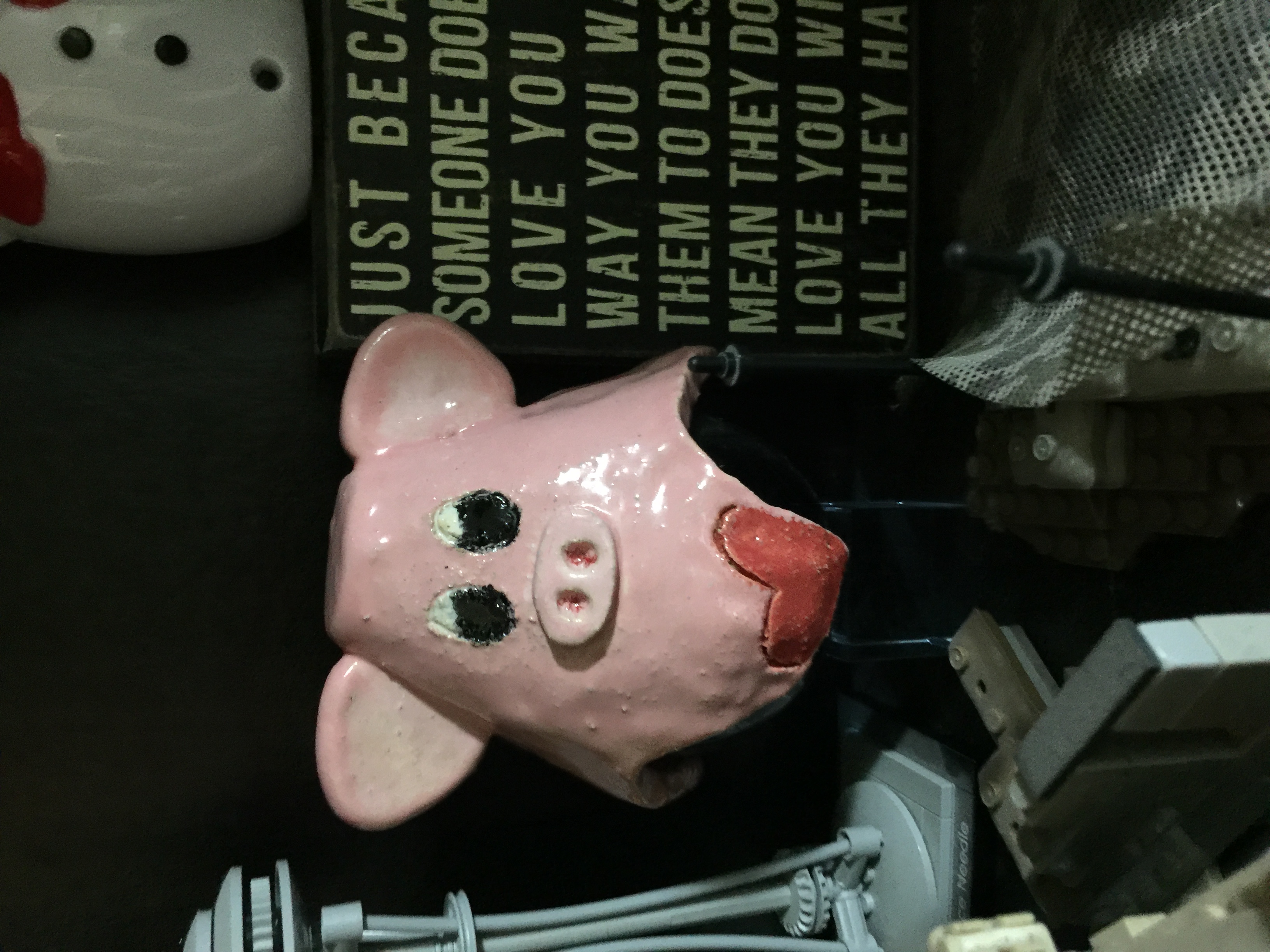 a pig crafted ceramic, pink with red heart