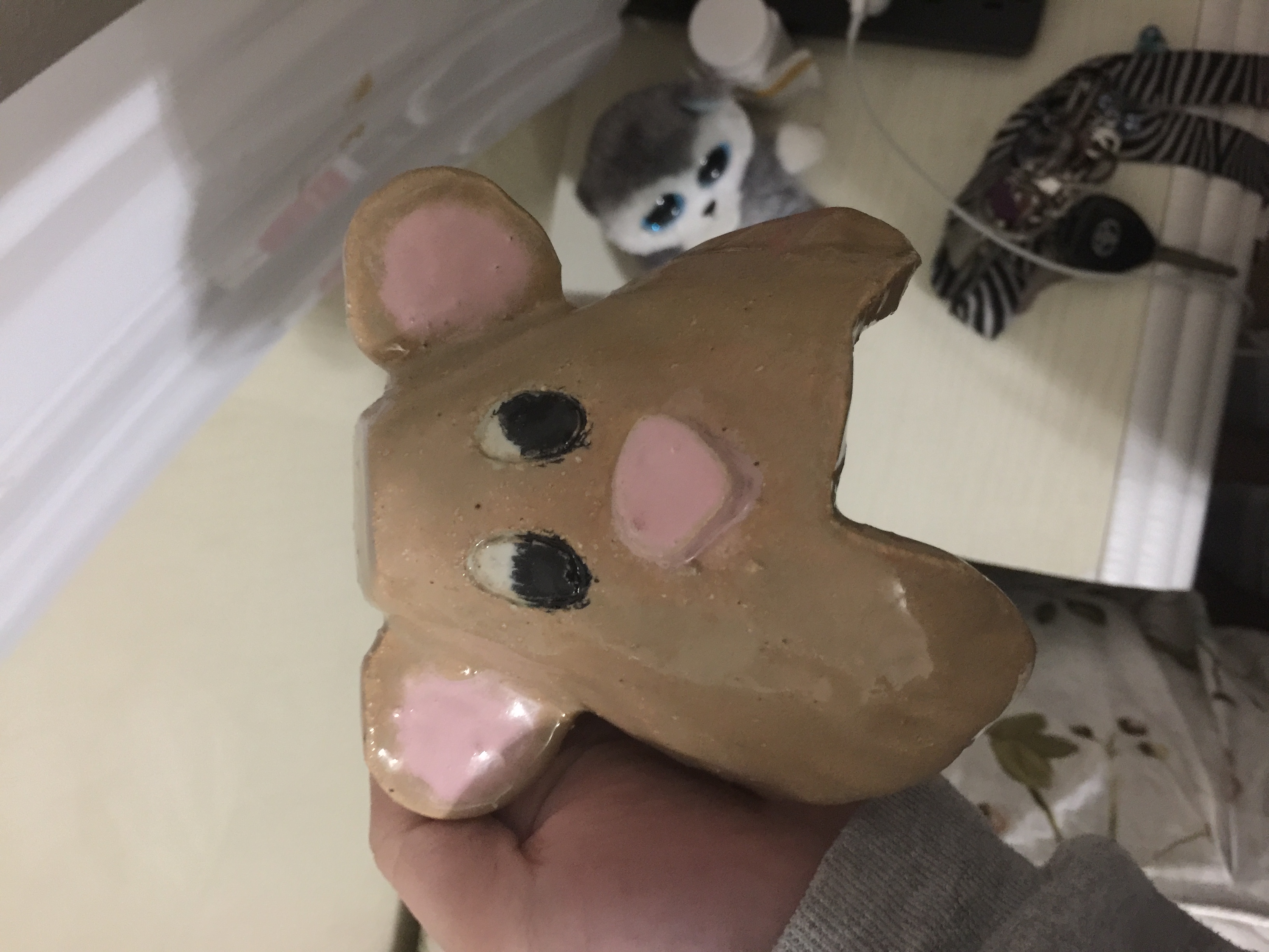 a bear crafted ceramic, brown with heart shape indentwith pink nose