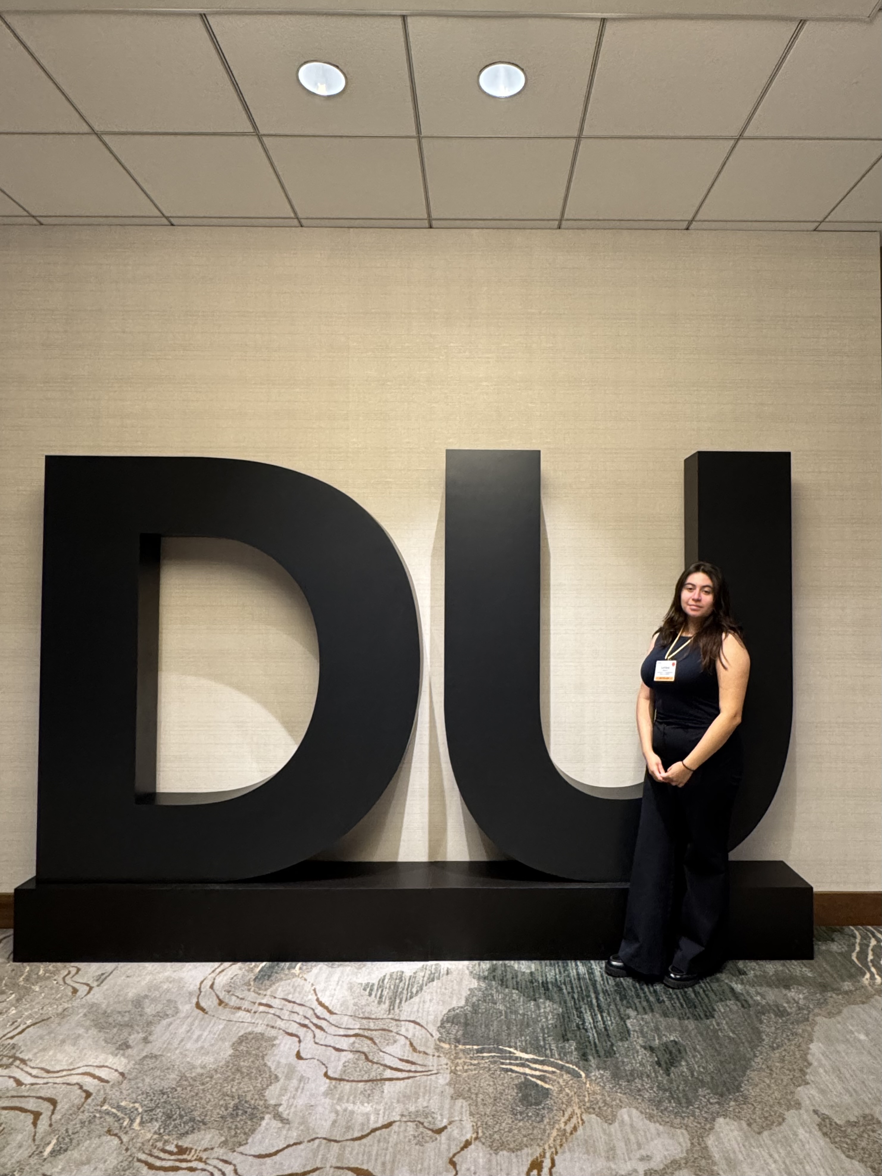 Laysha sitting on the letters DU (Deloitte University)