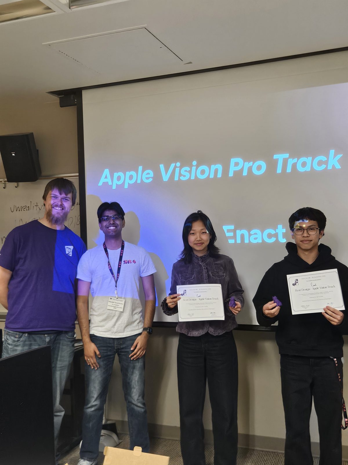The Enact team with their awards at the Hack the AM closing ceremony, in front of a screen reading Apple Vision Pro Track